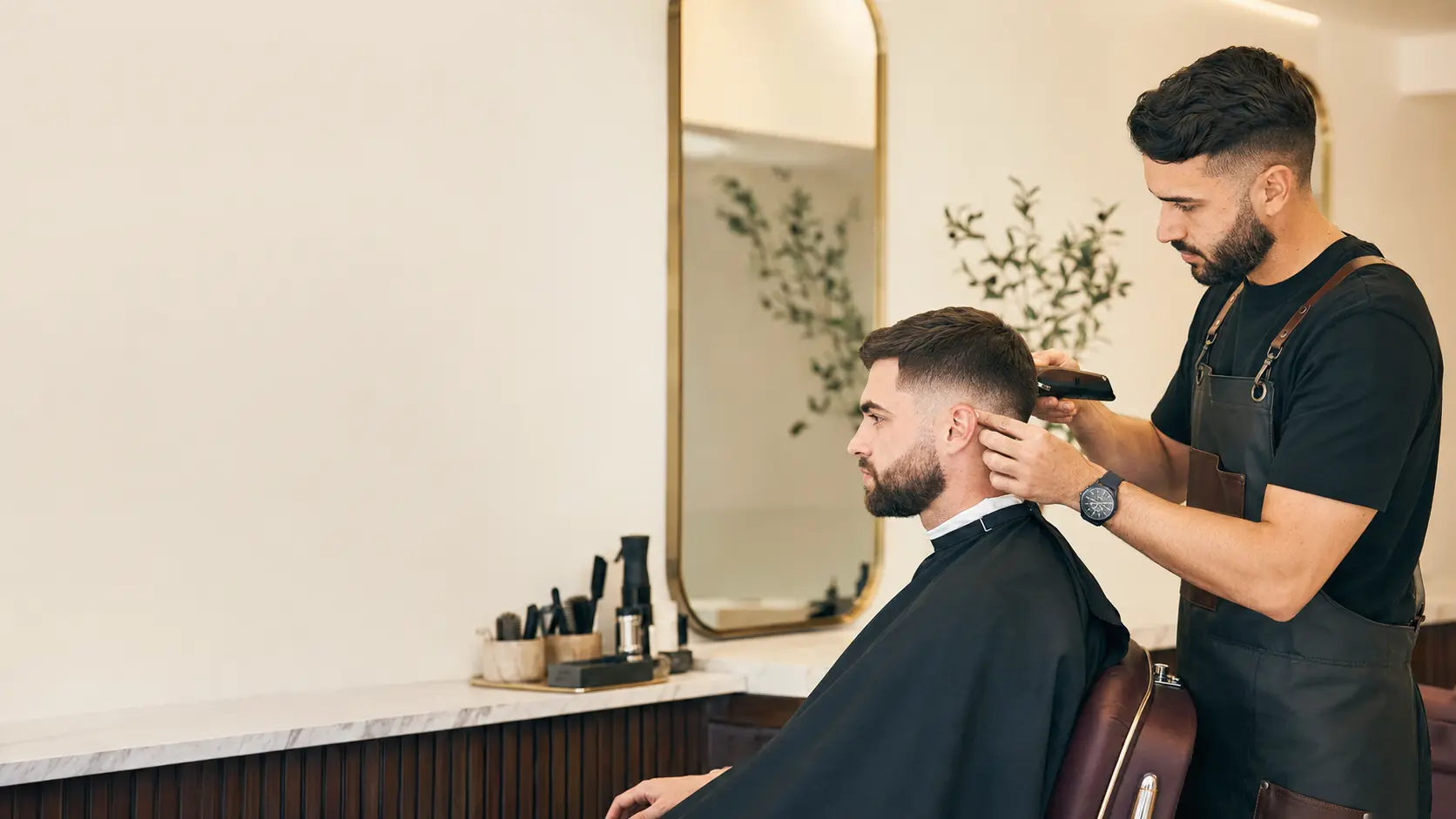 Barber finishing a modern fade haircut
